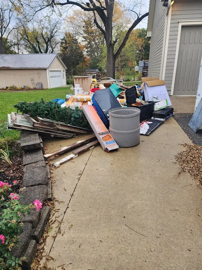Dumpster being loaded with debris for Estate Cleanout Dumpster Rental in Sauk Rapids